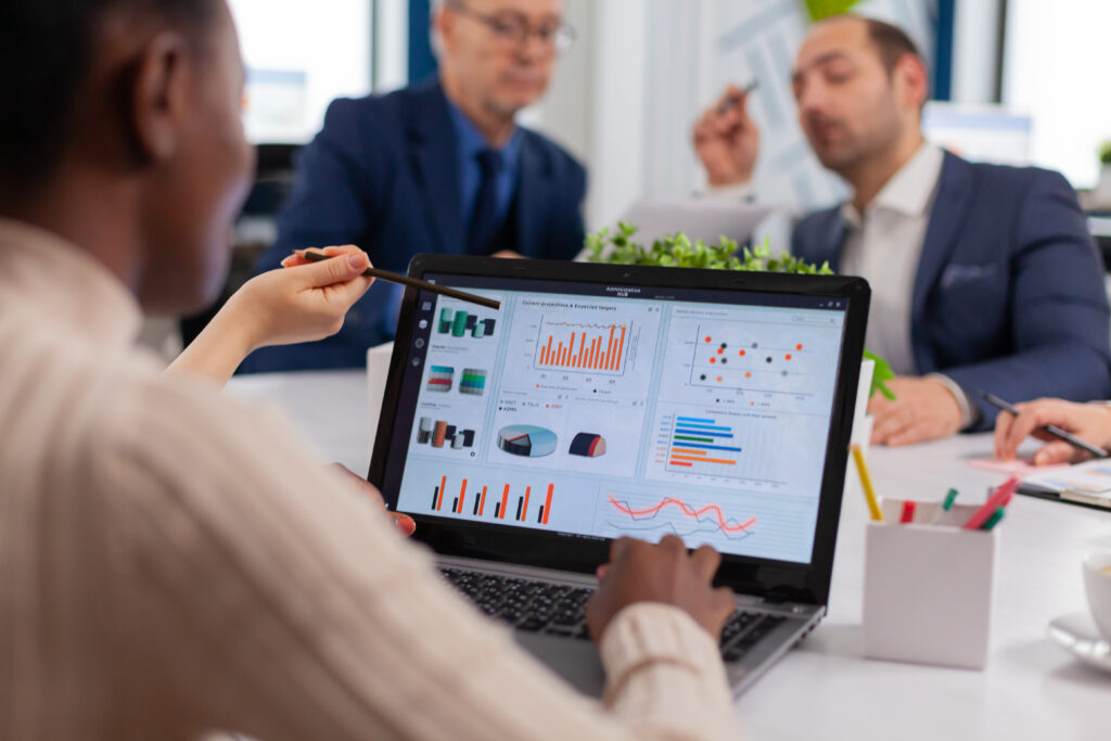 multi ethnic business team sitting at table in office center speaking